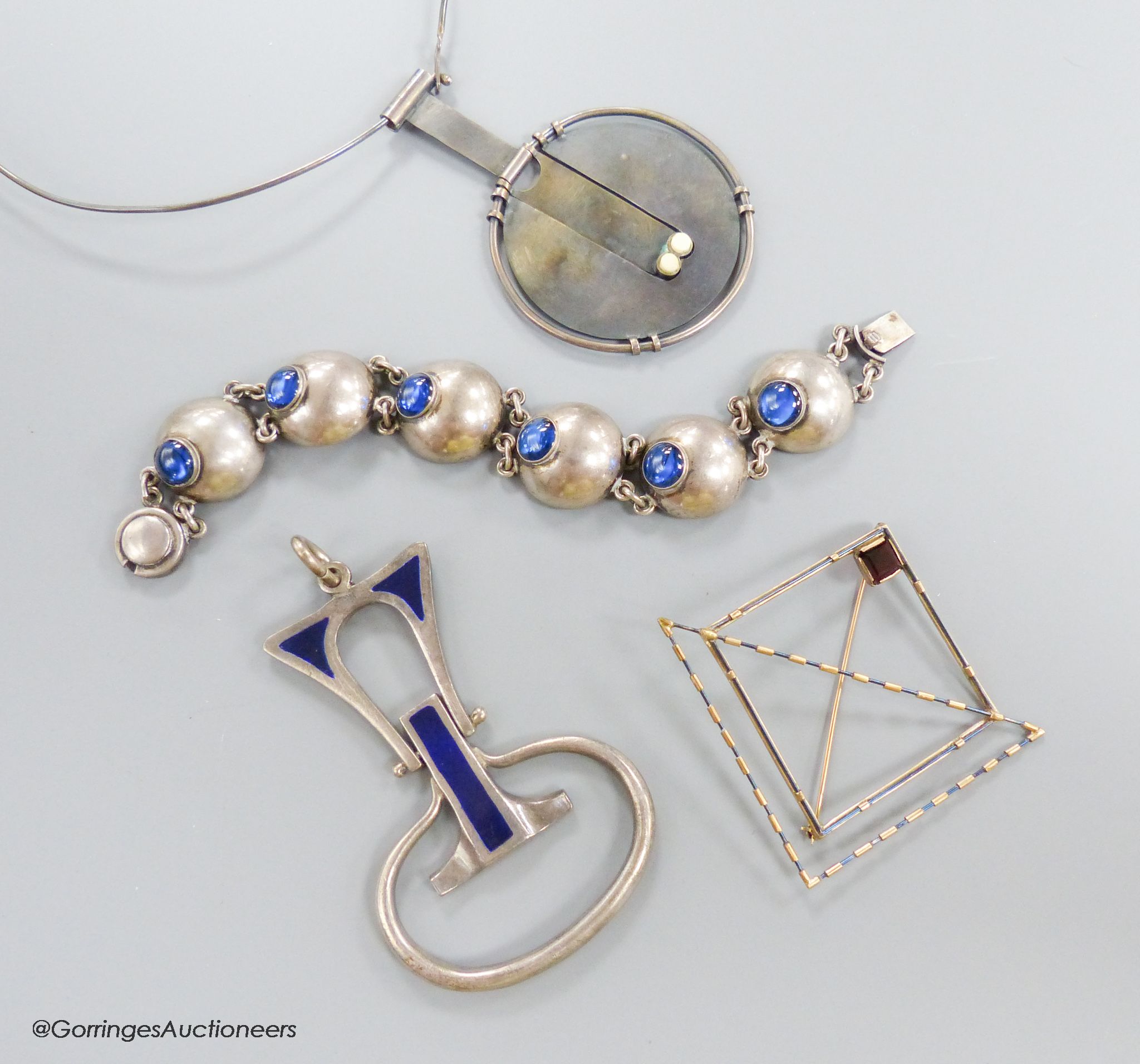 A stylish 1970's silver and blue enamel set pendant, maker E&N?, 78mm, gross 45.2 grams, a Scandinavian? 925 pendant necklace, a modernist square brooch and a blue paste and white metal bracelet.